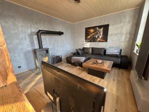 a living room with a couch and a table at Canossa Lodge in Bad Harzburg