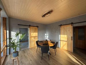 a dining room with a wooden table and chairs at Canossa Lodge in Bad Harzburg