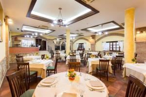 a dining room with white tables and chairs at Villa Santa Caterina in Montalto Uffugo