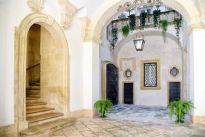 an entry to a building with an archway and stairs at La SignoraDelDuomo in Lecce