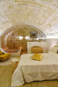 a bedroom with a large bed with a stone ceiling at La SignoraDelDuomo in Lecce