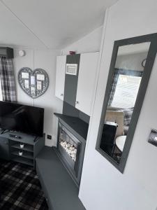 a living room with a fireplace and a mirror at Trecco Bay Private rentals in Newton