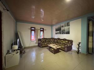 a living room with a couch and a table at Taibessi in Dili