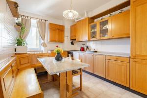a kitchen with wooden cabinets and a table at Trieste Sweet in Trieste