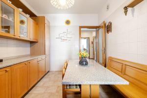 a kitchen with a table with a vase of flowers on it at Trieste Sweet in Trieste +18 photos
