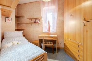 a bedroom with a bed and a desk and a window at Trieste Sweet in Trieste