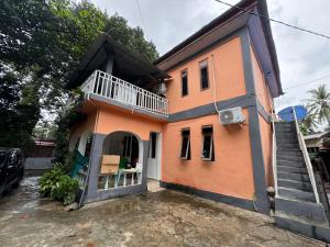 a house with a staircase in front of it at Taibessi in Dili
