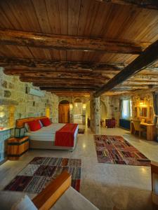 a bedroom with a bed and a couch in a room at Acropolis Cave Suite in Ürgüp