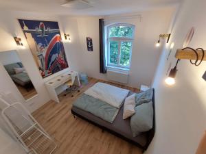 a small bedroom with a bed and a mirror at City Residenz Jena - modern, groß, ruhig, zentral, 2 Balkone, 4 Zimmer, Küche, Bad in Jena