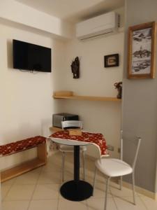 a room with a table and two chairs and a bed at Il Mughetto in Aosta