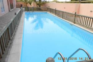 a large swimming pool in a apartment complex at Residence Poolside Haven in Grande Gaube