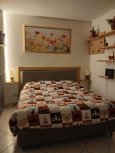 a bedroom with a bed with a quilt on it at Il Mughetto in Aosta