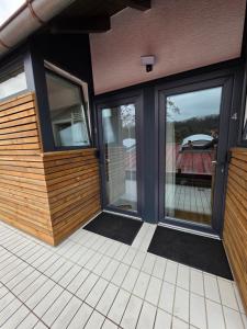 a screened porch with sliding glass doors on a house at Apartment mit Küche in Schwäbisch Hall