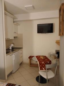 a kitchen with a table and a small table and chairs at Il Mughetto in Aosta