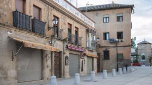 a group of buildings on a city street at Apartamentos Boutique Puerta de Reyes in Toledo