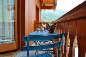 a blue table and chairs on a balcony at Hotel Mignon in Breuil-Cervinia