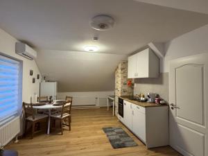 a kitchen and dining room with a table and a kitchen and a dining room at Apartment D&A in Albbruck