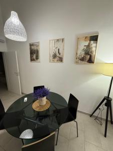 a dining room with a glass table and chairs at Apulian Dreams in Brindisi