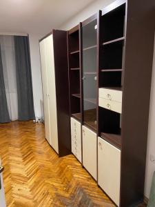 a room with a closet with shelves and a wooden floor at Venus 1 in Kula