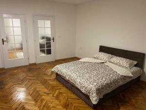 a bedroom with a large bed and two windows at Venus 1 in Kula