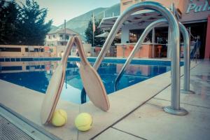 a group of tennis balls on a ramp next to a pool at Palmyra Beachfront Studios in Nydri