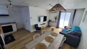 a living room with a couch and a table at Pépite citadine à St Pierre in Saint-Pierre +9 photos