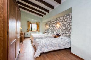 a bedroom with two beds and a stone wall at Villa Santa Caterina in Montalto Uffugo +81 photos