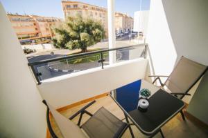 a balcony with a table and chairs and a window at Moraira Calamora in Moraira