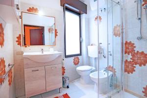 a bathroom with a toilet and a sink and a shower at Argo apartment, fronte mare, kaucana beach in Villaggio Azzurro +18 photos