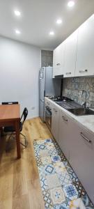 a kitchen with a sink and a stove at Casa dei nonni in Cetara