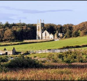 an old church on a hill in a field at Rosscarbery in Temple Bridge