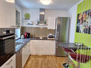 a kitchen with a stainless steel refrigerator and a table at modern und gemütlich in Linden