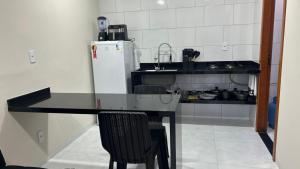 a small kitchen with a counter and a refrigerator at Residencial Ebenezer conforto perto da ufac in Rio Branco +2 photos
