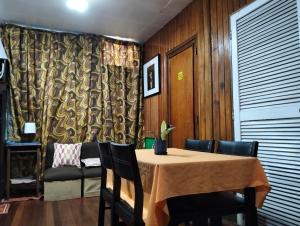 a dining room with a table and chairs at Jenny's transient house in Baguio