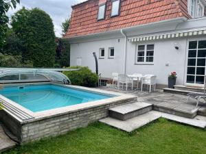 a swimming pool in the backyard of a house at Haus Doris in Perchtoldsdorf