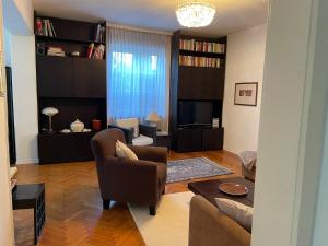 a living room with a couch and a tv at Haus Doris in Perchtoldsdorf