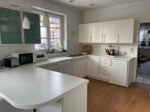 a kitchen with white cabinets and a white counter top at Haus Doris in Perchtoldsdorf