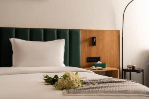 a bedroom with a bed with flowers on it at Grand Dior in Tashkent