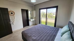 a bedroom with a bed and a large window at Villa Melara in Kızılyurd +28 photos
