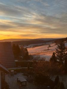 a view of a field at sunset from a house at Ferienzimmer Schürer in Lauter