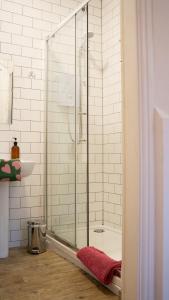 a shower with a glass door in a bathroom at Igloo Hybrid in Nottingham +107 photos