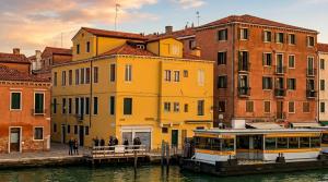 a boat in the water in front of buildings at Ca' sull' Acqua in Venice