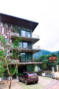 a building with a car parked in front of it at Mistara Ella in Ella