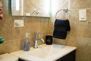 a bathroom sink with a bottle of soap and a mirror at Vacation Haven in Rolleville +50 photos