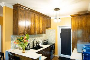 a kitchen with wooden cabinets and a kitchen island with flowers at Vacation Haven in Rolleville
