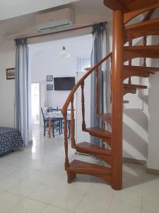 a wooden staircase in a living room with a table at Poseidone Ponza in Ponza