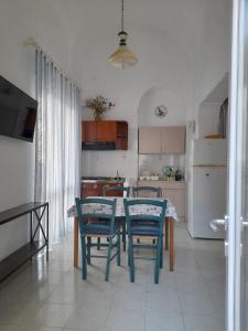 a kitchen with a table and chairs in a room at Poseidone Ponza in Ponza