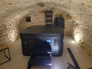 a room with a computer in a stone wall at Gite l'Amazonite in Laville-aux-Bois +14 photos