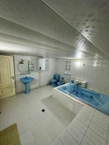 a bathroom with a tub and a toilet and a sink at Imran Guest House in Samarkand +37 photos
