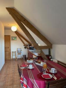 a dining room with a table with red table cloth at Grand Mainguet in Saint-Lambert-la-Potherie